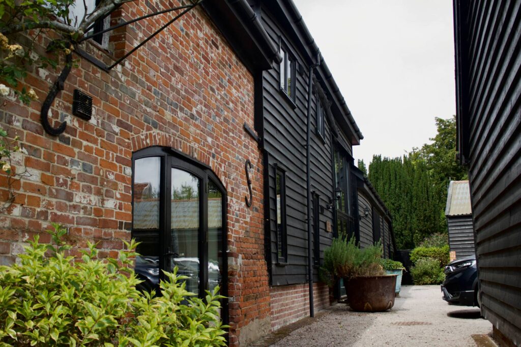 The 18th century brick section of Owls End with its arched glazed door