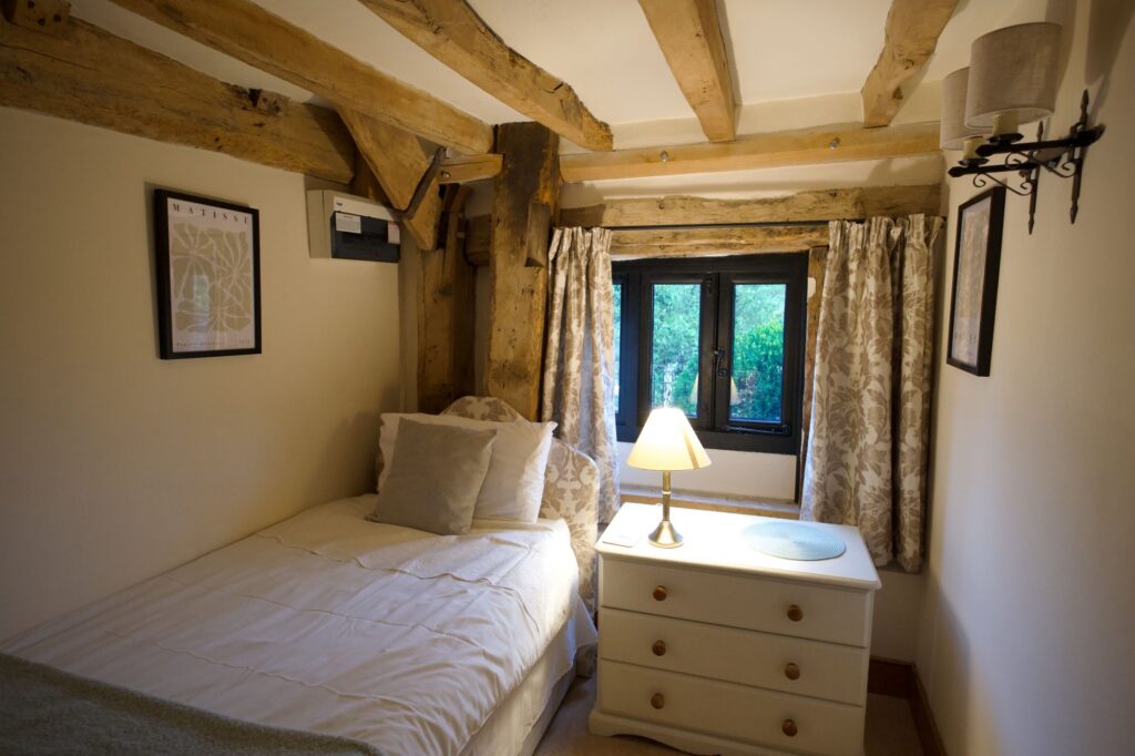 The small single bedroom on the ground floor, with a window onto the garden