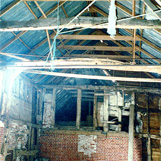 One of the barns before it was converted, with its old timber frame and tin roof